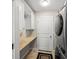Laundry room with washer, dryer, and built-in cabinets at 1358 Moonmist Dr # B4, Sarasota, FL 34242