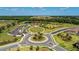 Aerial view of community with landscaping, lake, and clubhouse at 14118 Florida Rosemary Dr, Bradenton, FL 34211