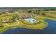 Aerial view of community with lake, pool, and clubhouse at 14118 Florida Rosemary Dr, Bradenton, FL 34211