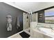 Modern bathroom with a walk-in shower and a bathtub at 14118 Florida Rosemary Dr, Bradenton, FL 34211