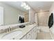 Bathroom with double sinks, granite countertop, and a bathtub at 14118 Florida Rosemary Dr, Bradenton, FL 34211