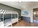 Bright bedroom with twin-size beds and a mounted TV at 14118 Florida Rosemary Dr, Bradenton, FL 34211