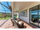 Outdoor patio with wicker furniture and lake view at 14118 Florida Rosemary Dr, Bradenton, FL 34211
