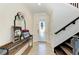 Bright entryway with wood and iron staircase, decorative console table and mirror at 14118 Florida Rosemary Dr, Bradenton, FL 34211