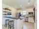 Modern kitchen with white cabinets, breakfast bar, and stainless steel appliances at 14118 Florida Rosemary Dr, Bradenton, FL 34211