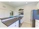 Modern kitchen with white cabinets, breakfast bar, and stainless steel appliances at 14118 Florida Rosemary Dr, Bradenton, FL 34211
