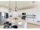 Bright kitchen with white cabinets, granite countertops, and stainless steel appliances at 14118 Florida Rosemary Dr, Bradenton, FL 34211