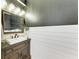 Stylish powder room with dark walls, shiplap, and a modern vanity at 14118 Florida Rosemary Dr, Bradenton, FL 34211