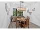Charming dining room featuring a round wooden table and chandelier at 577 Venice Ln, Sarasota, FL 34242