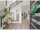 Bright entryway with modern staircase, bench, and view to living room at 577 Venice Ln, Sarasota, FL 34242