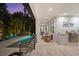 Outdoor oasis with a refreshing pool, patio seating, and built-in grilling station at 577 Venice Ln, Sarasota, FL 34242
