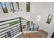 Modern staircase with metal railing, leading to upper level at 577 Venice Ln, Sarasota, FL 34242