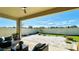 Back porch view features pavers, seating, and lush green landscaping at 12661 Oak Hill Way, Parrish, FL 34219