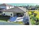 Aerial view of a backyard with a covered patio, stone pavers, landscaping, and partial privacy fence at 12661 Oak Hill Way, Parrish, FL 34219