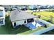 Aerial view of a manicured backyard with a patio, seating, landscaping and privacy fence at 12661 Oak Hill Way, Parrish, FL 34219