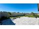 The backyard features a stone paver patio, garden beds, and lush green grass at 12661 Oak Hill Way, Parrish, FL 34219