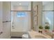 Bright bathroom with a bathtub, a shower, and a large mirror above the vanity with storage at 12661 Oak Hill Way, Parrish, FL 34219