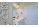 Nicely decorated half-bath featuring framed art, a decorative mirror, and a white vanity at 12661 Oak Hill Way, Parrish, FL 34219