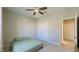 Bedroom featuring a ceiling fan, a double closet, and a comfortable bed at 12661 Oak Hill Way, Parrish, FL 34219