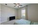 Cozy bedroom featuring soft carpet, natural light, and a ceiling fan at 12661 Oak Hill Way, Parrish, FL 34219
