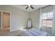 Cozy bedroom with a mirror, a window dressed with floral curtains, and neutral-toned decor at 12661 Oak Hill Way, Parrish, FL 34219