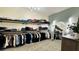 Spacious walk-in closet features ample storage, custom shelving, a full length mirror, and neutral carpet at 12661 Oak Hill Way, Parrish, FL 34219