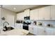 Bright kitchen featuring white cabinets, stainless steel appliances, and marble countertops at 12661 Oak Hill Way, Parrish, FL 34219