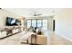 Bright living room with tile floors, large sectional, and sliding glass doors to the outdoor patio area at 12661 Oak Hill Way, Parrish, FL 34219