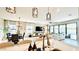Open-concept living space with modern lighting, seamlessly connecting the kitchen, dining, and living areas at 12661 Oak Hill Way, Parrish, FL 34219