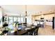 Bright, open floor plan with modern kitchen, dining area, and comfortable living room with tile flooring at 12661 Oak Hill Way, Parrish, FL 34219