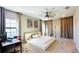 Bright and airy main bedroom featuring a large bed, desk, and windows with curtains at 12661 Oak Hill Way, Parrish, FL 34219