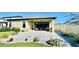 Back patio features pavers, stylish seating, and lush landscaping at 12661 Oak Hill Way, Parrish, FL 34219