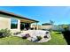 Inviting covered patio with elegant stone pavers and well-manicured landscaping at 12661 Oak Hill Way, Parrish, FL 34219