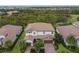 Two-story house with tile roof, two-car garage, and lush landscaping at 13107 Belknap Pl, Bradenton, FL 34211