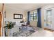 Bright entryway with a white sofa, geometric coffee table, and stained glass door at 13107 Belknap Pl, Bradenton, FL 34211