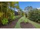 Lush tropical landscaping with a meandering pathway at 13107 Belknap Pl, Lakewood Ranch, FL 34211