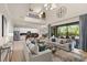Open living room showcasing high ceilings, large windows, and comfortable seating at 13107 Belknap Pl, Lakewood Ranch, FL 34211