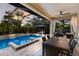 Relaxing pool area with covered patio, spa, and outdoor dining at 13107 Belknap Pl, Lakewood Ranch, FL 34211