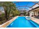 Inviting pool area with screened enclosure, spa, and waterfall feature at 13107 Belknap Pl, Lakewood Ranch, FL 34211