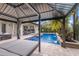 Relaxing poolside cabana with comfortable daybed at 13107 Belknap Pl, Lakewood Ranch, FL 34211