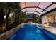 Stunning pool area with a covered patio, waterfall, and spa at 13107 Belknap Pl, Lakewood Ranch, FL 34211