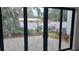 Private backyard patio with paver stones, lush landscaping, and modern sliding glass doors at 2318 Bay St, Sarasota, FL 34237