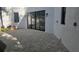 Spacious backyard patio with paver stones and modern sliding glass doors at 2318 Bay St, Sarasota, FL 34237