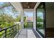 Private balcony with metal railing and treetop views at 2318 Bay St, Sarasota, FL 34237