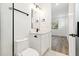 Modern bathroom with white tile, a white vanity, and black accents at 2318 Bay St, Sarasota, FL 34237