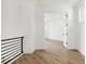 Bright hallway with hardwood floors and doors to bedrooms at 2318 Bay St, Sarasota, FL 34237