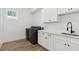 Laundry room with modern cabinets and a farmhouse sink at 2318 Bay St, Sarasota, FL 34237