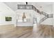 Two-story living room with modern staircase and kitchen view at 2318 Bay St, Sarasota, FL 34237