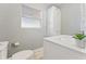 Updated bathroom with white vanity, toilet and marble shower at 1841 Buccaneer Dr, Sarasota, FL 34231