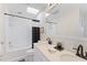Clean bathroom, featuring double vanity, bathtub and a skylight at 1841 Buccaneer Dr, Sarasota, FL 34231
